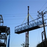 Crane lifts ramp